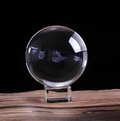 Solar system crystal ball showing planets inside K9 optical crystal sphere on metallic base