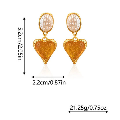 A pair of silver-tone stud earrings with a textured pleated oval love heart shape in various colour options.