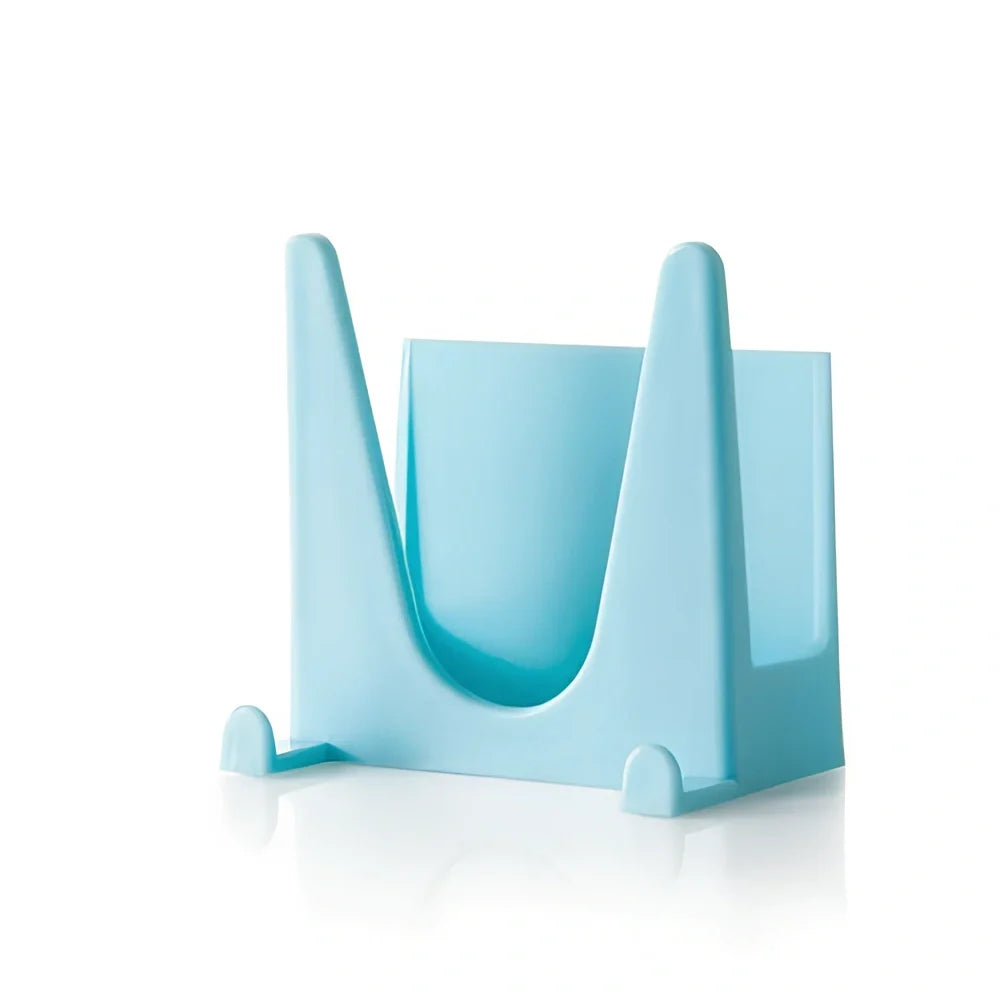 Blue plastic kitchen organiser mounted inside cabinet door holding spatula and spoon