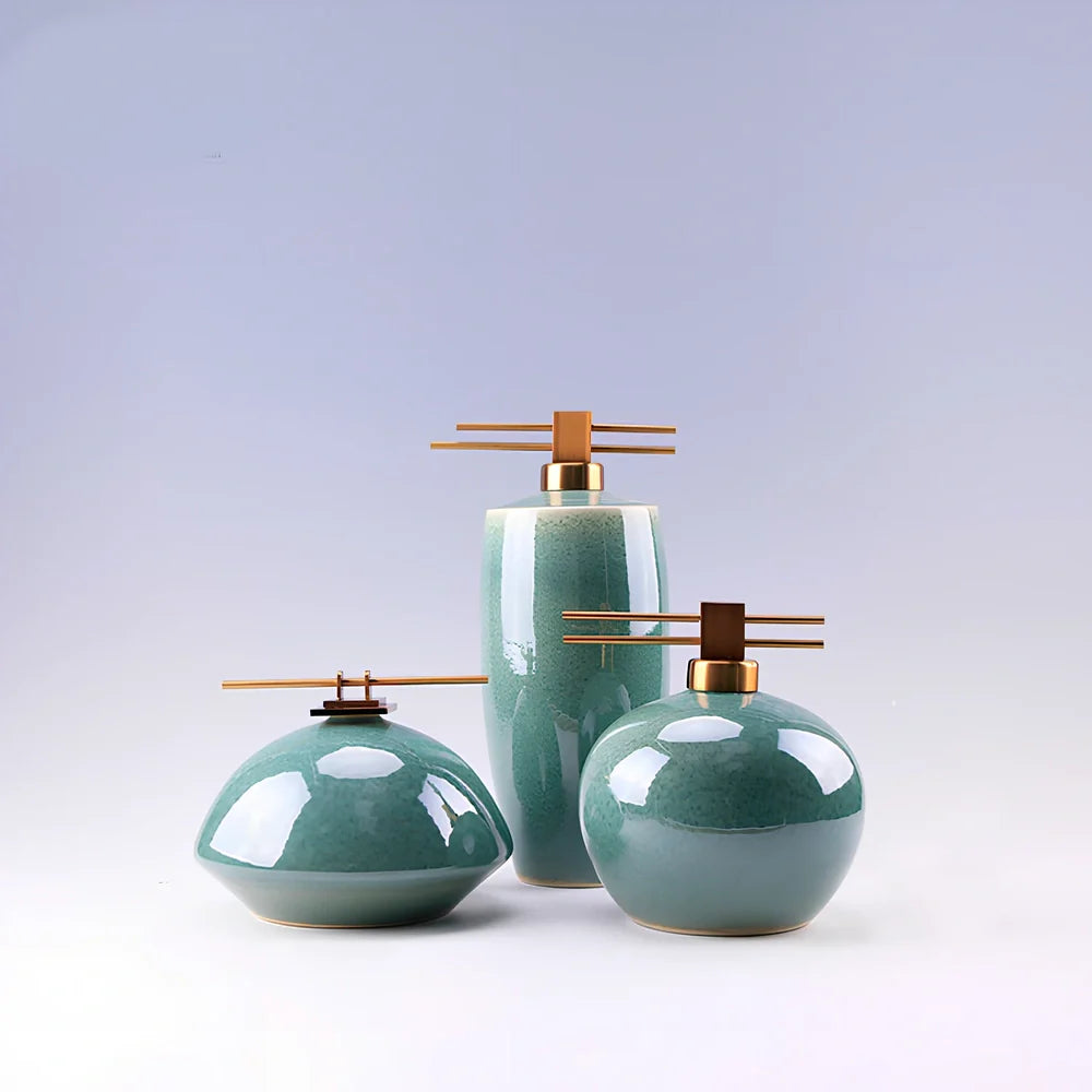 Handmade ceramic ornaments in graduated sizes with emerald green and golden sunlight glazes