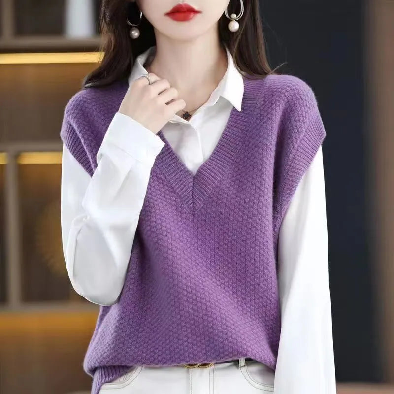 Women's creamy-white sleeveless knit vest with a raised 3D pattern, shown on a hanger.
