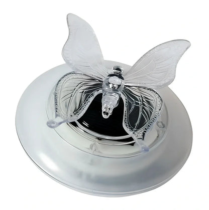 Solar LED float lamp with butterfly design floating on garden pond water surface