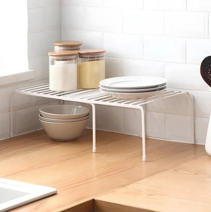 White retractable kitchen shelf extended to 60cm with spices and oils organised on metal surface