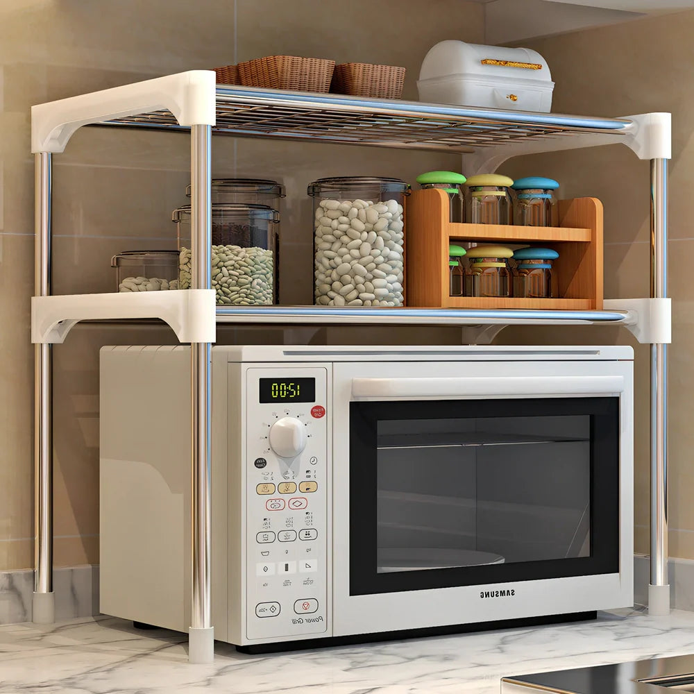 Silver and white microwave shelf rack with iron tubes and plastic connectors measuring 56.9cm wide