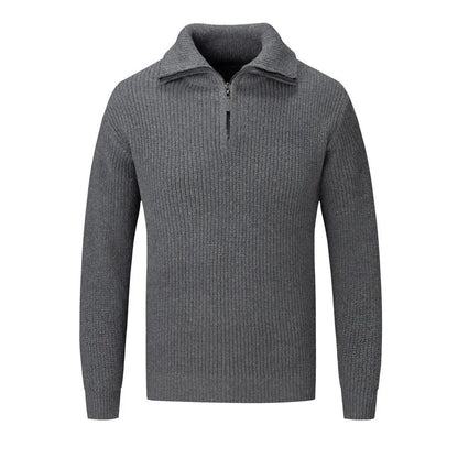 A man wearing a solid-colour slim-fit loose pullover sweater in a neutral colour.