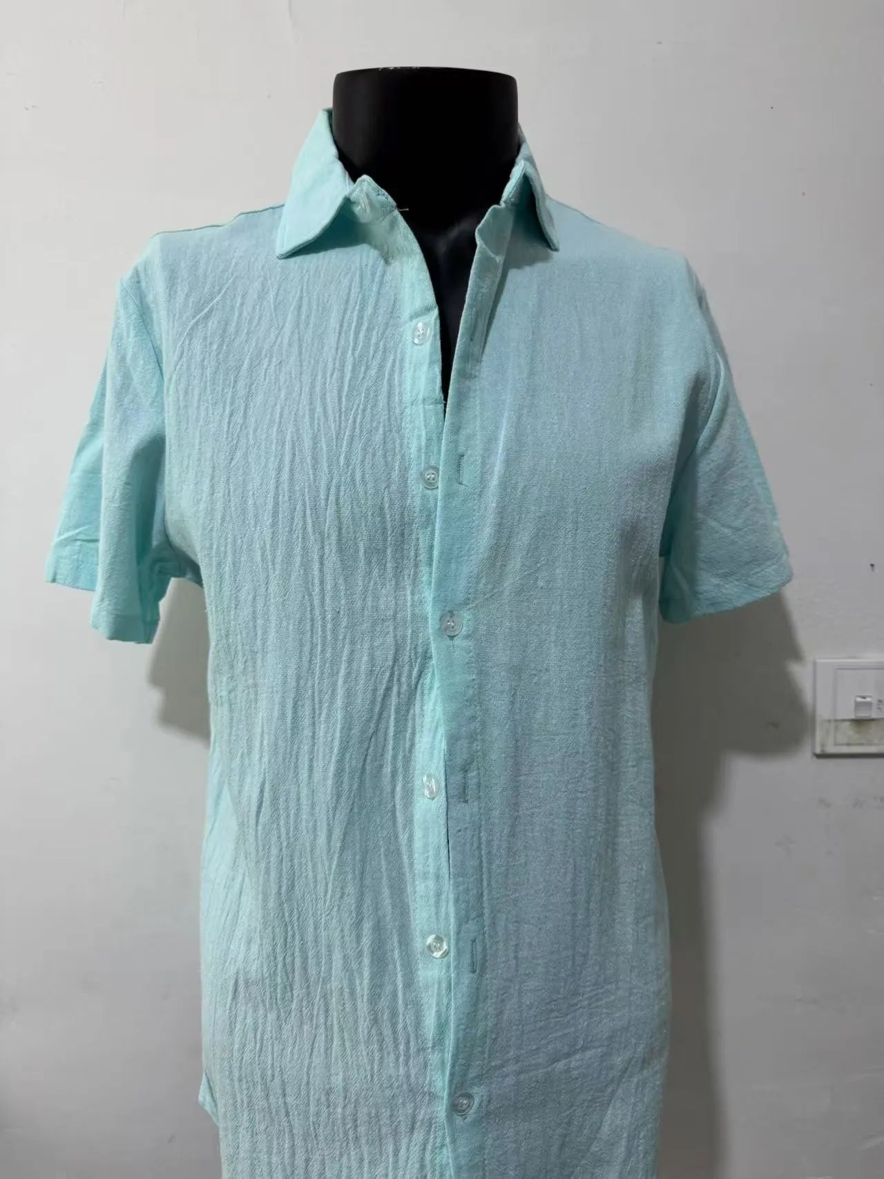 Men's light blue short sleeve linen blend casual shirt with a loose fit.