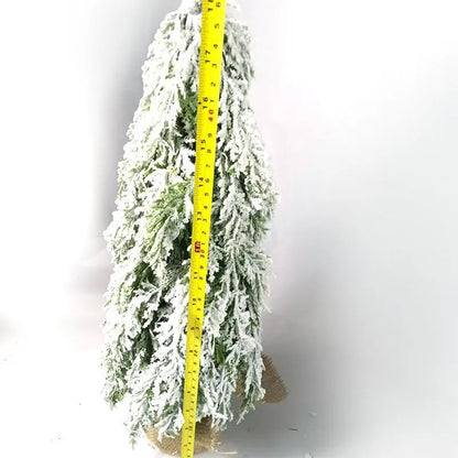 Compact 24-inch white pre-lit artificial Christmas tree with snow-covered branches on a table.