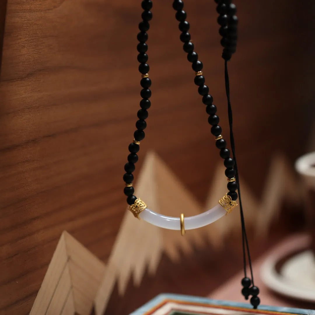 Women's Chinese style necklace with matte black agate pendant and silver ball bead chain.