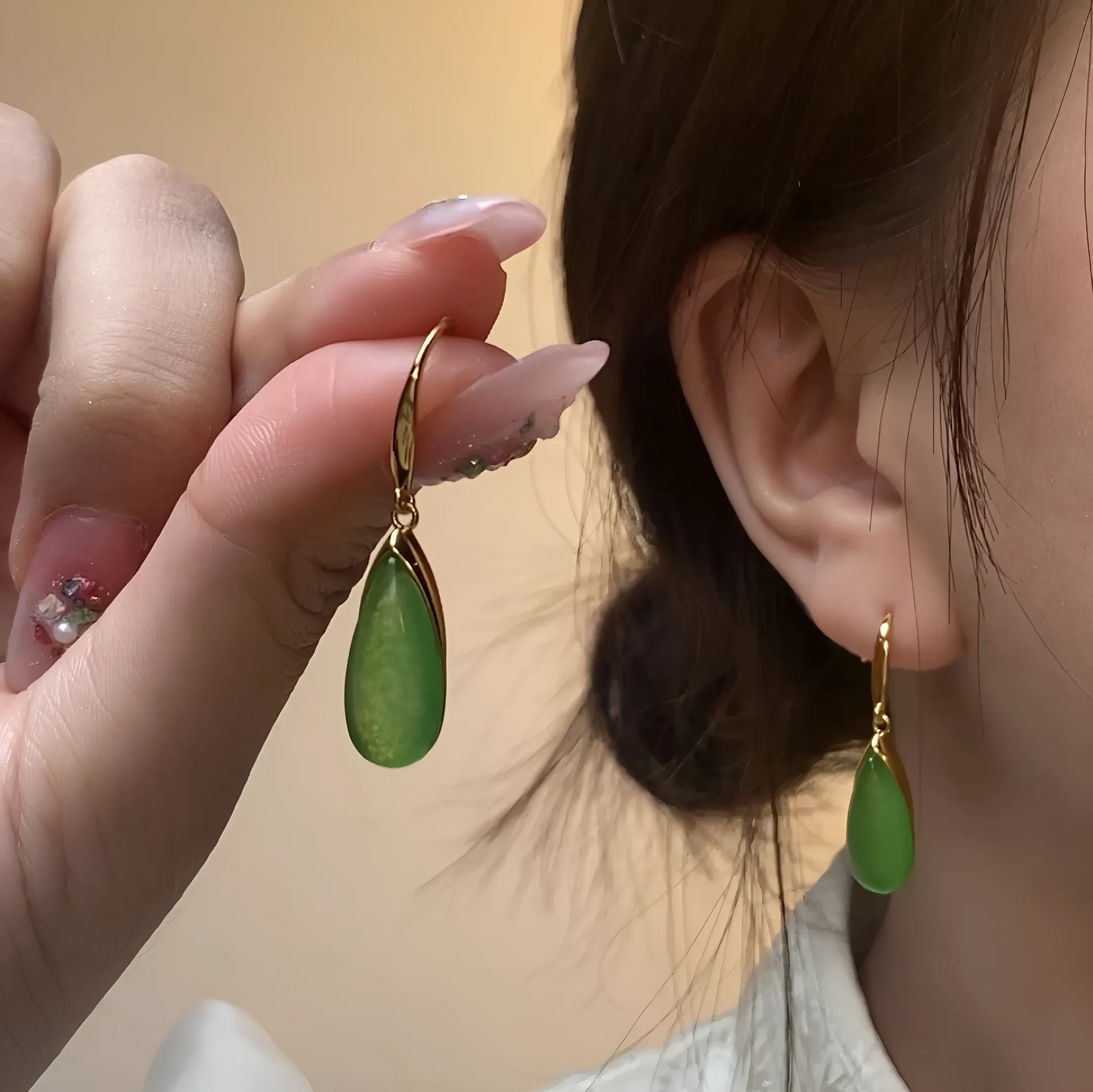A pair of retro-style geometric copper earrings with water droplet details in a jade-toned electroplated finish.