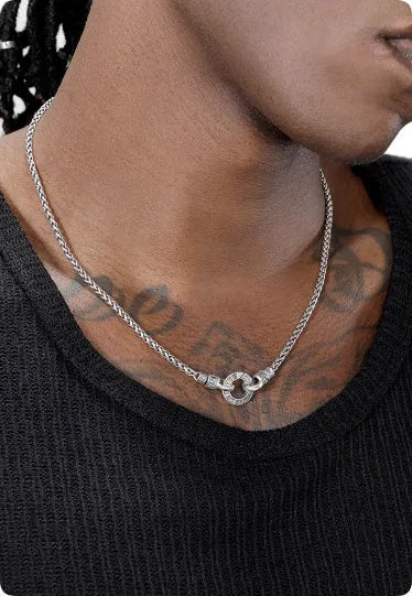 Simple polished S925 sterling silver chain necklace on a dark background, showing its length and clasp.