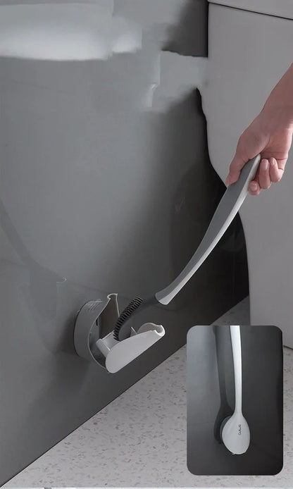 Black silicone bathroom cleaning brush with soft head and curved ergonomic handle for easy grime removal