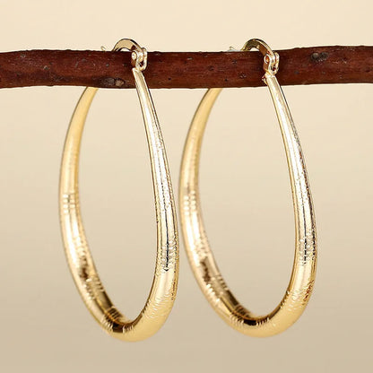 Geometric drop-shaped ear clip earrings with electroplated finish in various colours