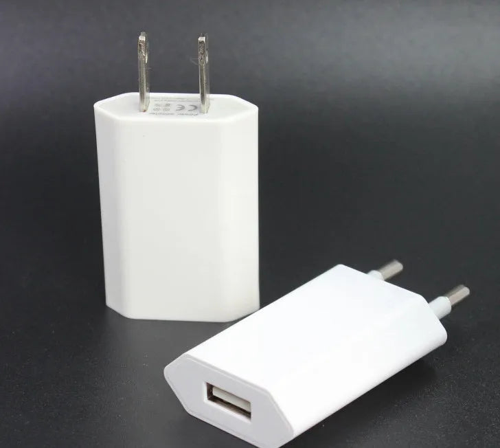 White USB wall charger with UK plug and a white Lightning cable for iPhone and iPad charging