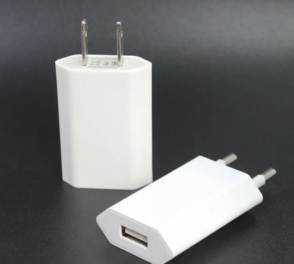 White USB wall charger with UK plug and a white Lightning cable for iPhone and iPad charging