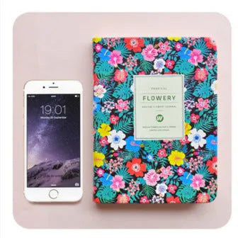 Bo Shide floral notepad with fabric-imitation leather cover in green, shown open on a desk.