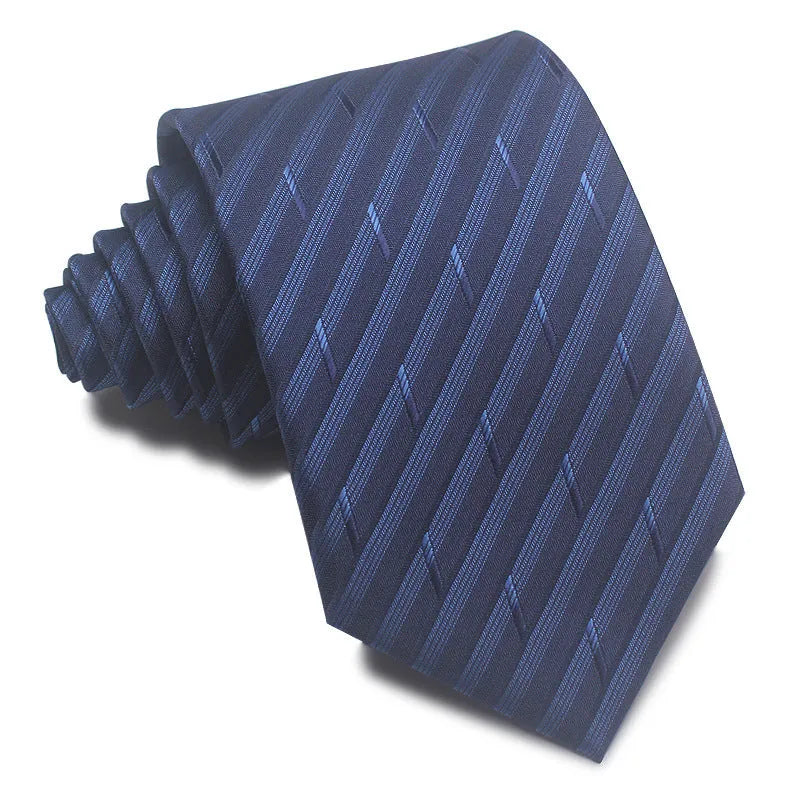 Close-up of a red and black striped jacquard weave tie with an arrow tip, showing texture.