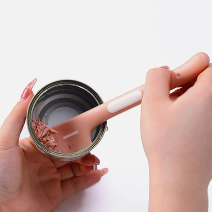 Green long-handled plastic spoon for scooping pet food from a can.