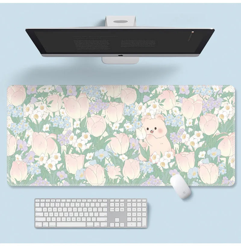 Large floral pattern mouse pad on a wooden desk with a computer mouse.