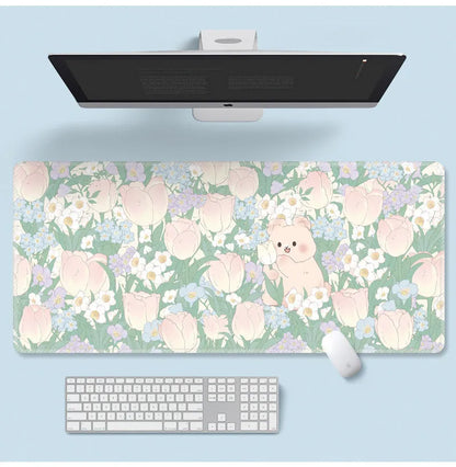 Large floral pattern mouse pad on a wooden desk with a computer mouse.