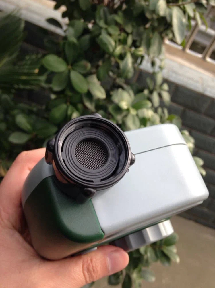 Green garden irrigation controller with LCD display and rotating dial for programming watering schedules