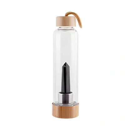 Crystal infused glass water bottle with bamboo lid showing mineral crystal inside 25cm tall container