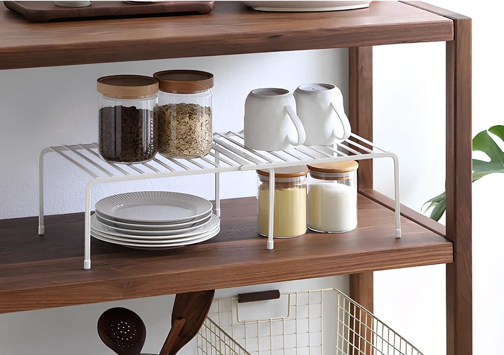 White retractable kitchen shelf extended to 60cm with spices and oils organised on metal surface