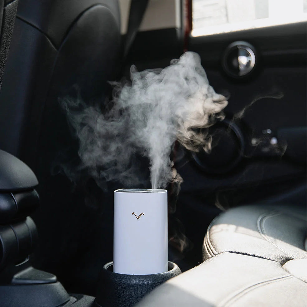 Blue aromatherapy projection humidifier measuring 7.5cm square with water tank and control buttons