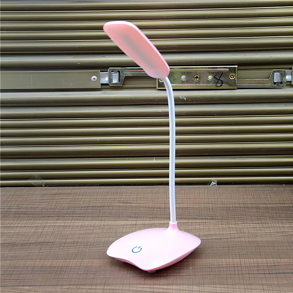 White foldable LED desk lamp with touch button and USB charging port on a desk