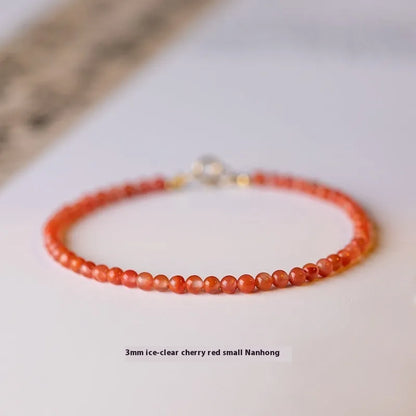 Close-up of a women's retro bracelet with a Southern Red Agate stone in cherry red on a wrist.