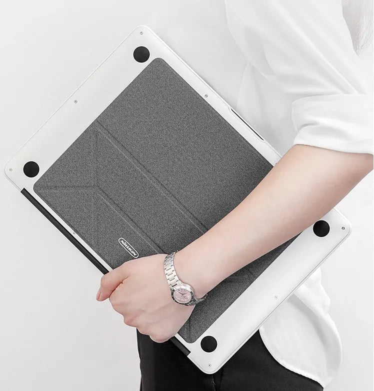 Blue or grey foldable laptop cooling stand with anti-slip surface on a desk.