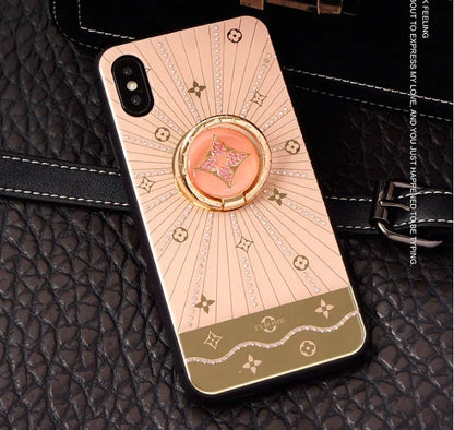 Gold-plated iPhone ring stand holder adorned with luxury diamond crystals, shown in rose gold and white gold colours.