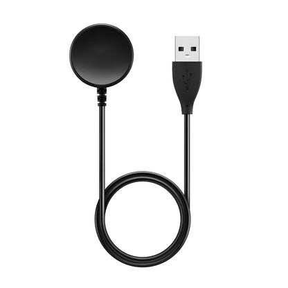 Black plastic USB wireless charging dock for smartwatches on a flat surface.
