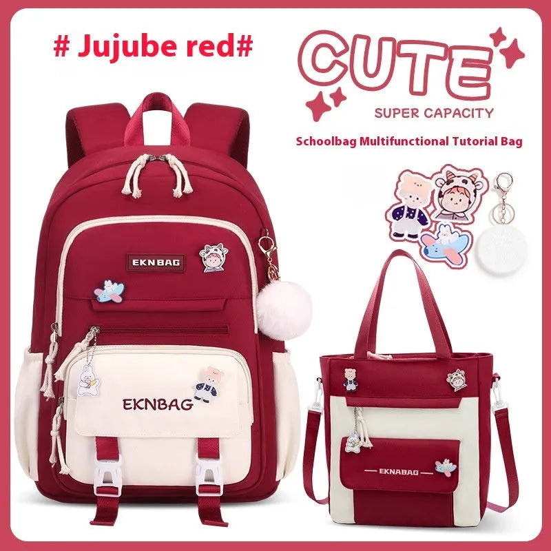 Pink waterproof Oxford cloth school backpack for girls with curved shoulder straps, shown with matching pencil case.