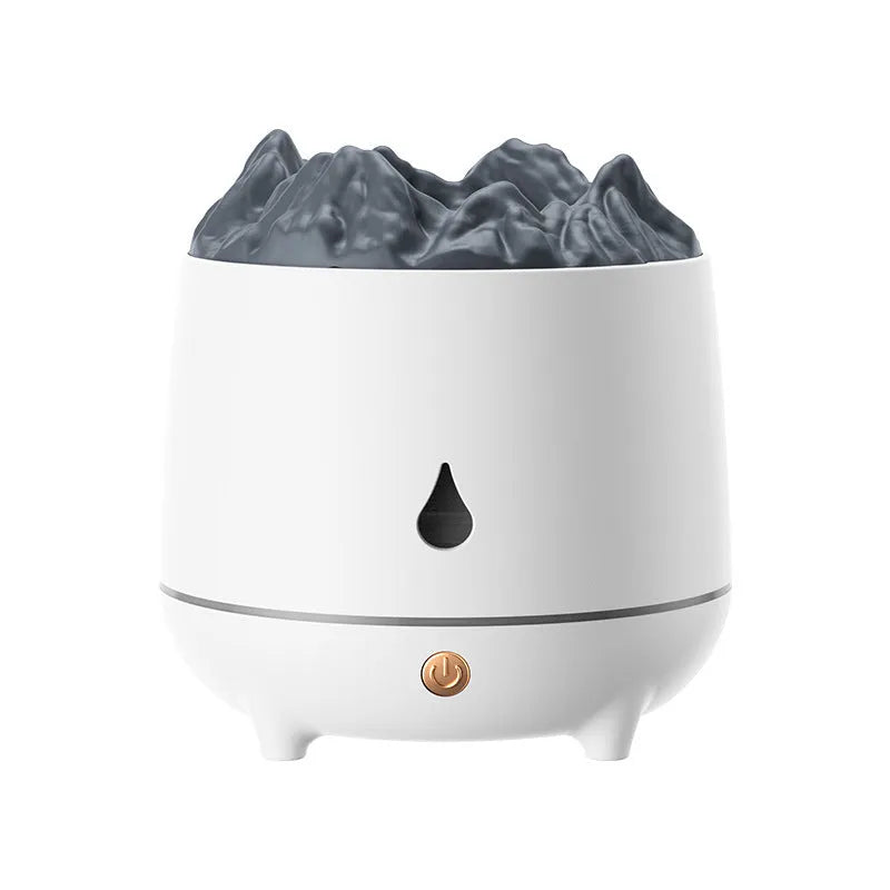 White volcano-shaped humidifier with USB cable on a wooden table, emitting mist.