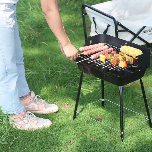 Portable outdoor barbecue oven with metal grill for camping and outdoor use