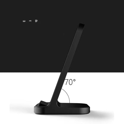 Dark grey vertical wireless charging stand for Apple iPhone on a desk.