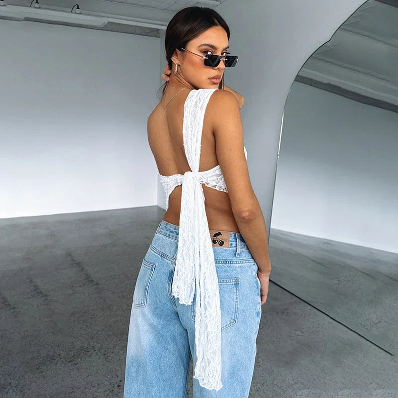 A stylish backless lace top in various colors with an asymmetrical sloped neckline and waistless design, perfect for summer streetwear fashion.