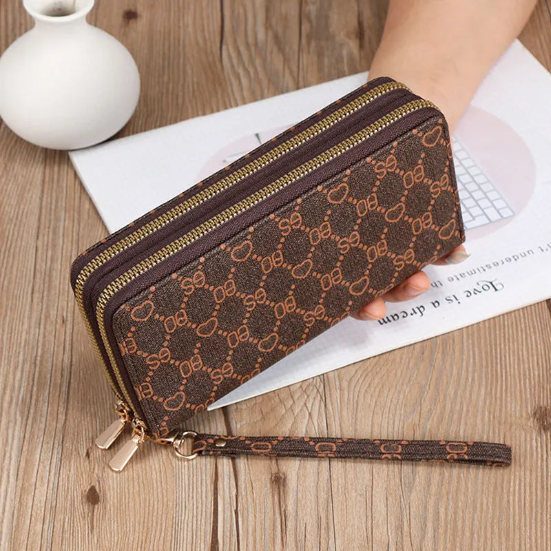 Long black retro-style PU leather wallet clutch with a printed pattern, showing a mobile phone pocket and a zippered coin purse.
