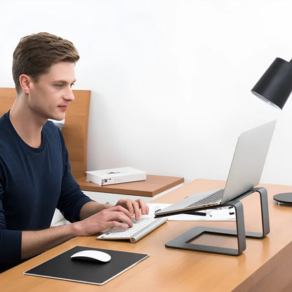 Black aluminium alloy laptop stand raising a laptop for ergonomic desktop use