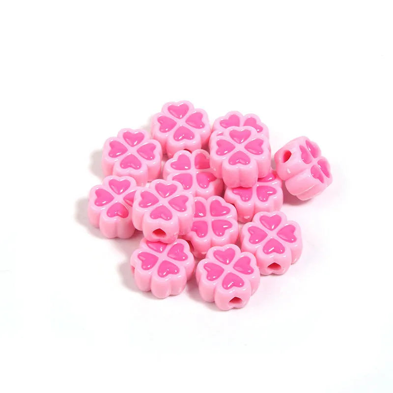 Assorted frosted acrylic four-leaf clover shaped beads in pink, green, and yellow, 15mm diameter.