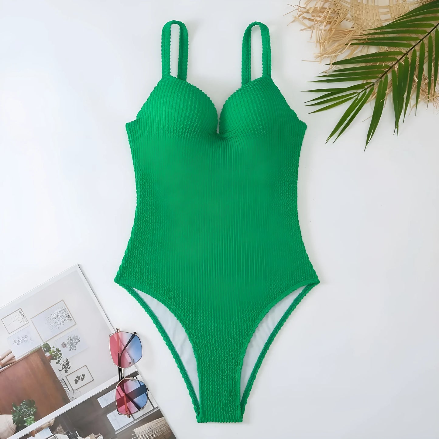 Women's black one-piece swimsuit with a sunken vertical stripe detail, shown on a model, featuring a sleeveless design.