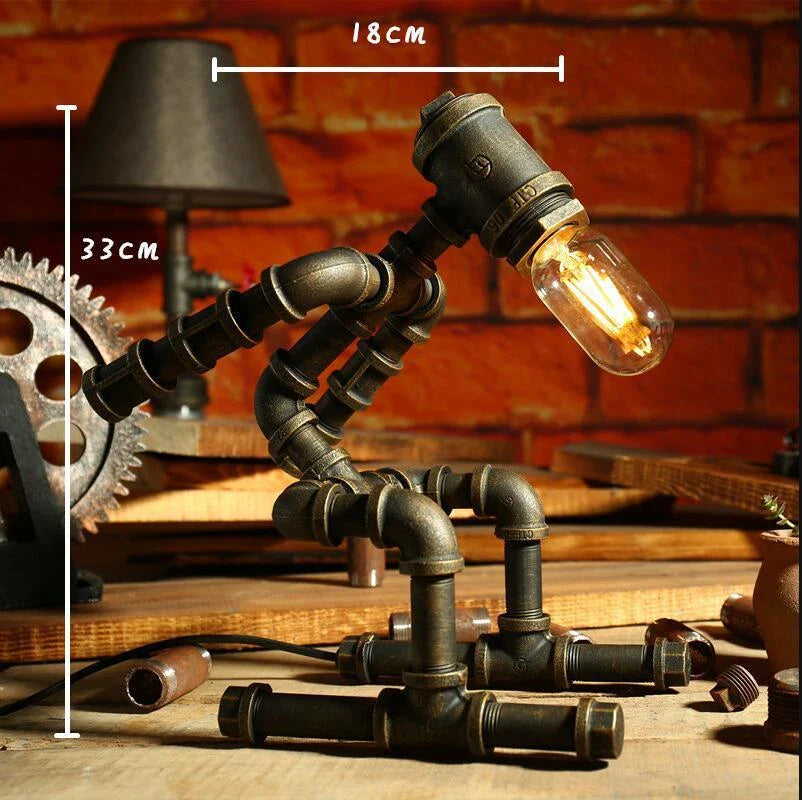 Vintage industrial iron pipe table lamp with soft, warm lighting and a green bronze finish