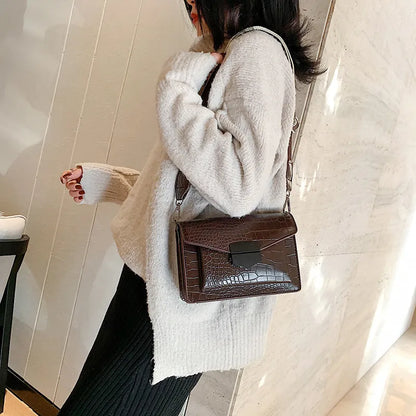 Vintage crossbody bag in black showing 20cm width, crossbody strap, and front storage compartment
