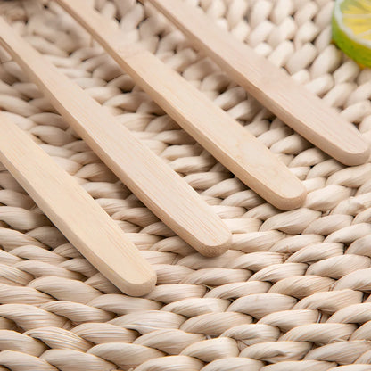 Bamboo toothbrush with wood colour handle measuring 18.5cm long with soft white bristles in protective tube