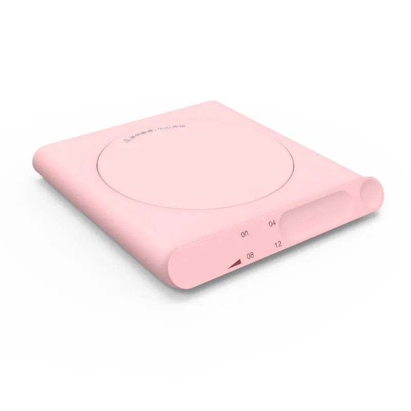 Pink and white USB heating cup pads with mechanical dials on a desk