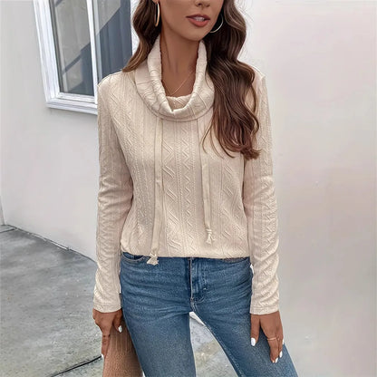 Apricot coloured long sleeve hooded pullover sweater with drawstring on a hanger