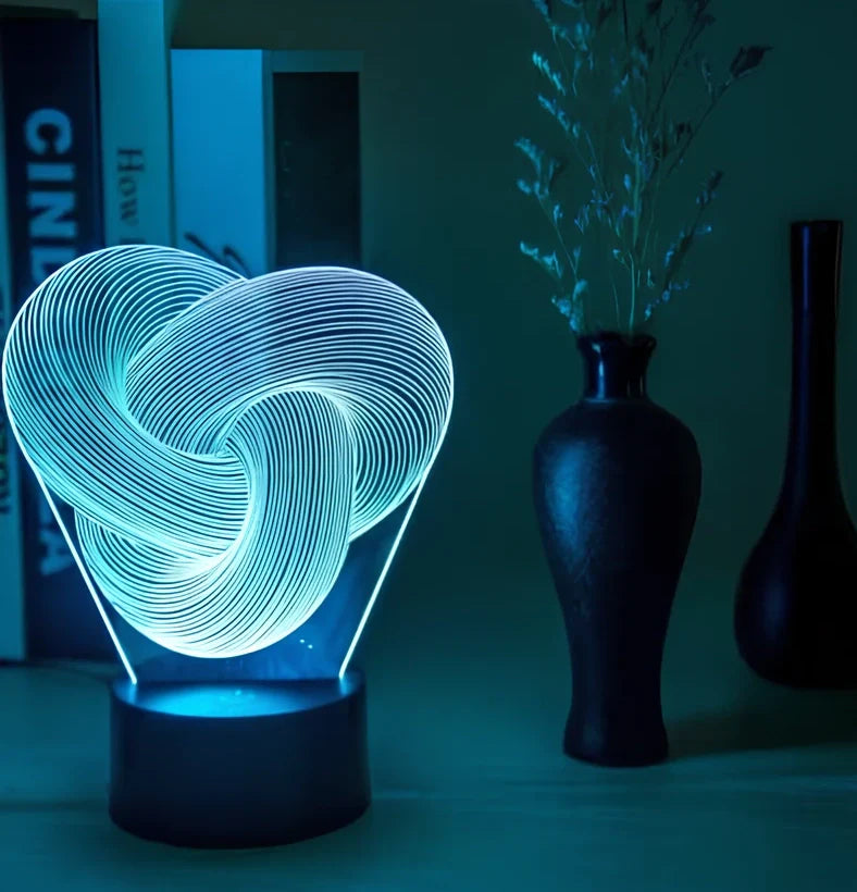 Twist abstract LED 3D night light with acrylic construction showing colour gradient illumination on dark surface