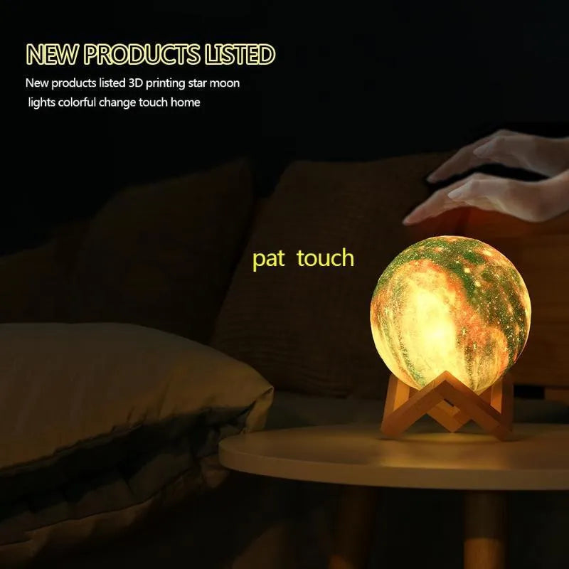 3D-printed spherical lunar night light with LED colours and remote control on a dark surface