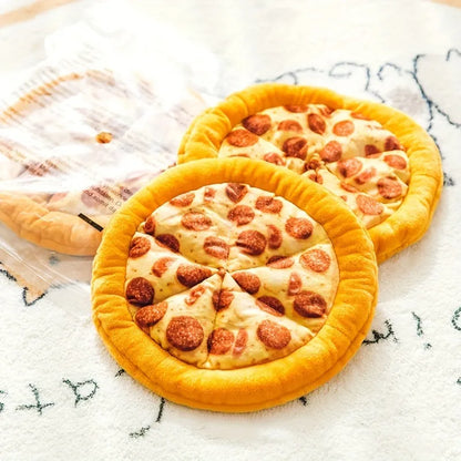 Bright yellow squeaky dog toy shaped like a pizza slice with a soft teddy fabric surface