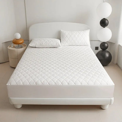 Diamond lattice quilted bamboo fibre mattress protector set in solid colour on a bed.
